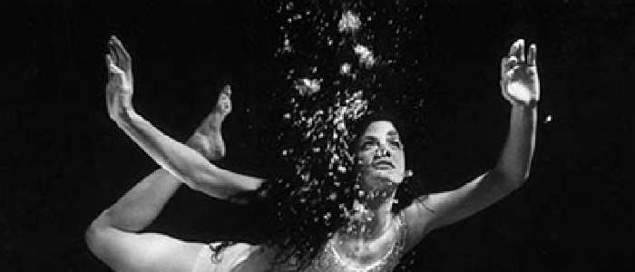 a woman underwater with bubbles