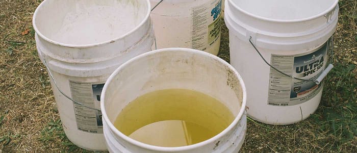 bucket with water in the front, more buckets in the background