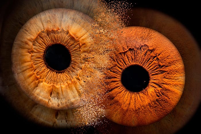 photo of two eyes taken in macro mode, of different persons and same color and simulating collision