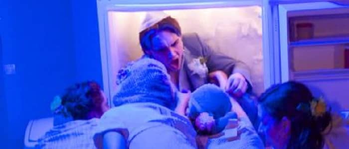 four actors staring at a man in a freezer